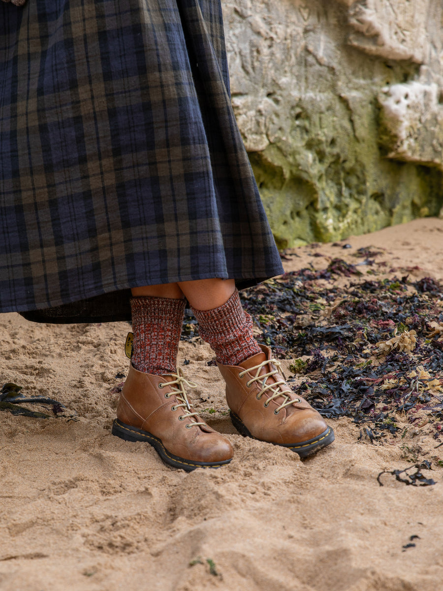 Model wears Women's British Made Merino Wool faltering stripe socks in Rust