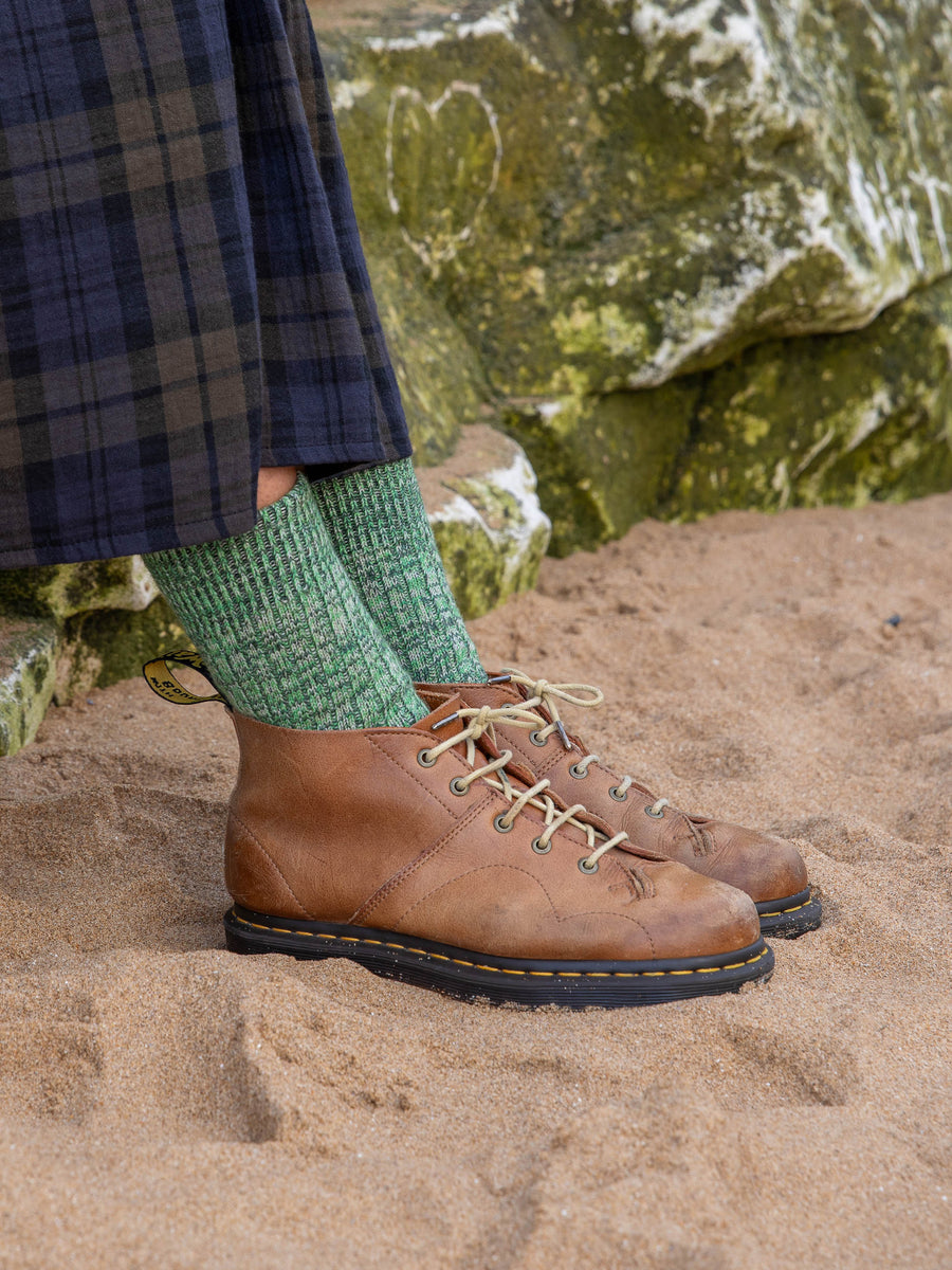 Model wears womens merino wool British made faltering stripe socks in Green