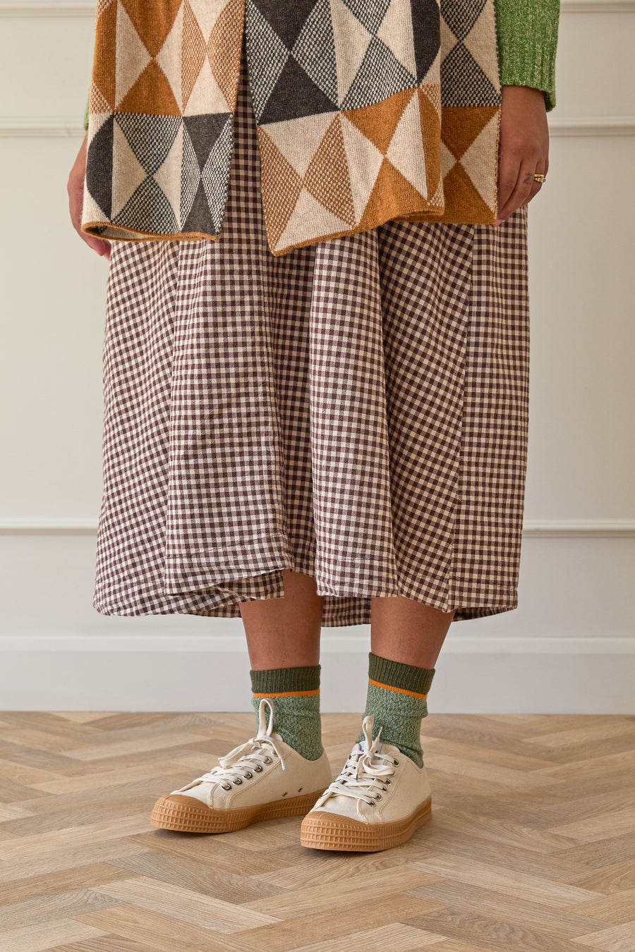 Model wears green marl organic cotton socks with gingham dress