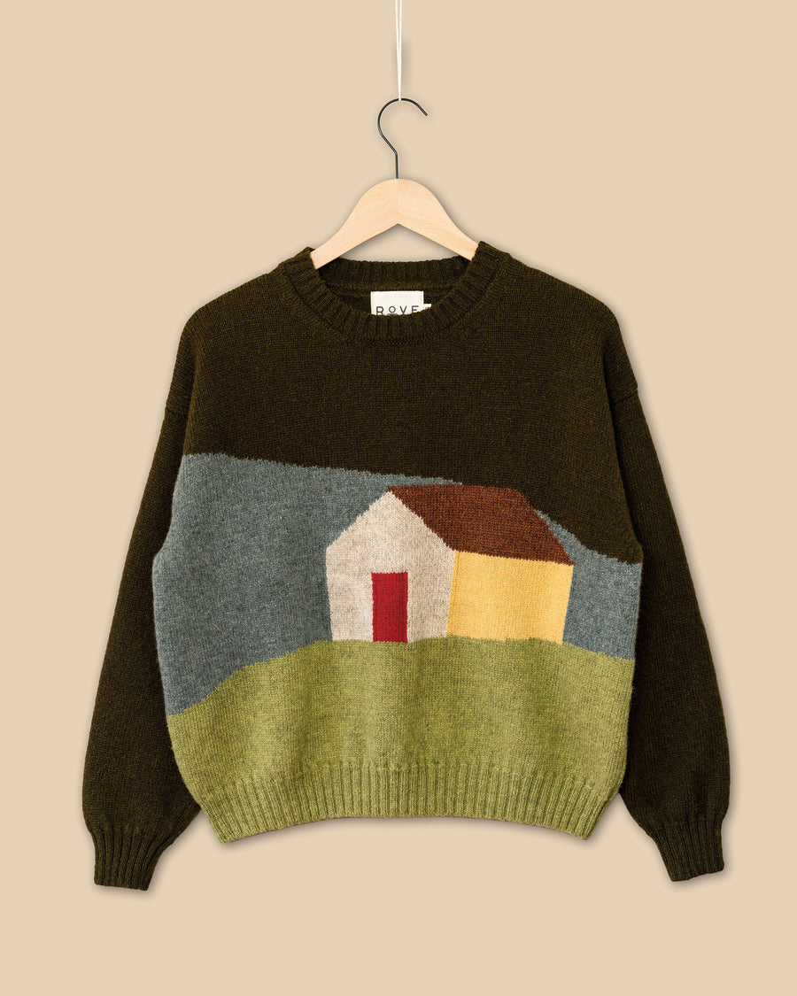 Knitted sweater with a house design on a beige background